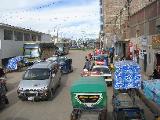 Main street in Juliana, on the way to Puno. Note the green motorized taxi and the blue one, without engine, just next to it.