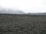 Not far from the crater, the moon-like land is black and powdery