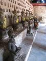 Around the temple, wall are lined up with more statues of Buddha, including in the small holes